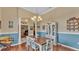 Charming dining room with a rustic table, chandelier, and adjacent sitting area at 2817 High Winds Ln, Lakeland, FL 33813