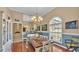Bright dining room showcases a rustic wood table, elegant chandelier, and large windows at 2817 High Winds Ln, Lakeland, FL 33813