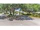 Community entrance with well-manicured landscaping and decorative community sign at 2817 High Winds Ln, Lakeland, FL 33813