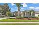 Charming one-story home with a lush lawn, mature trees, and well-manicured landscaping at 2817 High Winds Ln, Lakeland, FL 33813