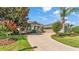 Inviting home exterior with lush landscaping, a curved driveway, and a charming swing at 2817 High Winds Ln, Lakeland, FL 33813