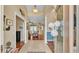 Inviting foyer with tile floors, columns, and views into the living areas at 2817 High Winds Ln, Lakeland, FL 33813