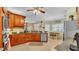 Open kitchen with wood cabinets, stainless steel appliances, tile floors and eat-in dining area at 2817 High Winds Ln, Lakeland, FL 33813