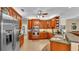 Spacious kitchen showcases wood cabinets, stainless steel appliances, tile floors and ample counter space at 2817 High Winds Ln, Lakeland, FL 33813