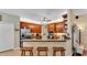 Traditional kitchen features wood cabinetry, stainless steel appliances, and a breakfast bar with seating at 2817 High Winds Ln, Lakeland, FL 33813