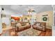 Open-concept living room featuring hardwood floors that connect to the kitchen at 2817 High Winds Ln, Lakeland, FL 33813