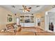 Comfortable living room features built-in shelving, a ceiling fan, and a plush leather couch at 2817 High Winds Ln, Lakeland, FL 33813