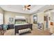 Bright bedroom with a tray ceiling, fan, accent art and carpet flooring at 2817 High Winds Ln, Lakeland, FL 33813