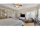 Bedroom features a tray ceiling, ceiling fan, and lounge chair with a slider to the outdoors at 2817 High Winds Ln, Lakeland, FL 33813