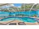 A sparkling swimming pool inside a screened enclosure with an expansive outdoor entertaining area at 2817 High Winds Ln, Lakeland, FL 33813