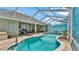 Sparkling pool area with screened enclosure, lounge chairs, and lush landscaping at 2817 High Winds Ln, Lakeland, FL 33813