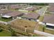 Aerial view of a home featuring a fenced backyard, a playset, and lush green grass at 2958 Flying Blackbird Rd, Bartow, FL 33830