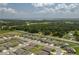 An aerial view showcases the community, with the house indicated with an arrow and a view of a lake in the distance at 2958 Flying Blackbird Rd, Bartow, FL 33830