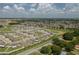 An aerial view of the home, surrounded by the community, green spaces, and streetscapes at 2958 Flying Blackbird Rd, Bartow, FL 33830