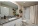 Bathroom featuring white vanity, granite counters, and shower over tub with curtain at 2958 Flying Blackbird Rd, Bartow, FL 33830