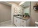 Bathroom features a white vanity with granite countertop and ample storage at 2958 Flying Blackbird Rd, Bartow, FL 33830