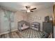 Bedroom with a gray crib, chevron rug and curtains, dresser and ceiling fan at 2958 Flying Blackbird Rd, Bartow, FL 33830