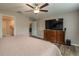 Bedroom featuring wood-look flooring, a ceiling fan, large television and neutral paint at 2958 Flying Blackbird Rd, Bartow, FL 33830