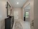 Inviting foyer with tiled floor, a decorative mirror, and elegant console table at 2958 Flying Blackbird Rd, Bartow, FL 33830