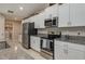 Modern kitchen featuring white cabinets, stainless steel appliances, and granite countertops at 2958 Flying Blackbird Rd, Bartow, FL 33830