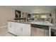 Kitchen island with granite countertop, stainless steel dishwasher, and open to dining area at 2958 Flying Blackbird Rd, Bartow, FL 33830