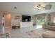 Bright living room featuring tile floors, a large television, and sliding glass doors to the backyard at 2958 Flying Blackbird Rd, Bartow, FL 33830