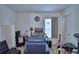 Bedroom featuring a desk, monitor, drum set and comfortable blue armchair at 312 Walnut Ln, Auburndale, FL 33823
