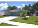 Charming single-story home with a well-maintained lawn and attached two car garage at 312 Walnut Ln, Auburndale, FL 33823