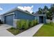 A charming home with stone accents and a well-manicured lawn leading to the front door at 312 Walnut Ln, Auburndale, FL 33823