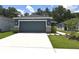 Charming single-story home with a well-maintained lawn and attached two car garage at 312 Walnut Ln, Auburndale, FL 33823