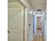 Hallway with hardwood floors leads to rooms with white doors at 312 Walnut Ln, Auburndale, FL 33823