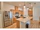 Spacious kitchen featuring a stainless steel refrigerator and stylish island with pendant lighting at 312 Walnut Ln, Auburndale, FL 33823