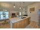 Bright, open kitchen with a modern island, stainless steel appliances, and view to the living space at 312 Walnut Ln, Auburndale, FL 33823