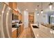 Modern kitchen featuring stainless steel appliances and a view into the dining area at 312 Walnut Ln, Auburndale, FL 33823