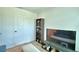 Inviting living room featuring a TV and shelving for storage at 312 Walnut Ln, Auburndale, FL 33823