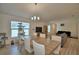 Open-concept living room with dining area, stylish furniture, and hardwood floors at 312 Walnut Ln, Auburndale, FL 33823