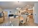 Open-concept living space with modern dining set, kitchen island, and comfortable seating area at 312 Walnut Ln, Auburndale, FL 33823