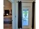 View from the bedroom doorway looking out onto a covered patio with outdoor seating at 312 Walnut Ln, Auburndale, FL 33823
