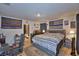 Comfortable main bedroom with wooden floors, desk, and flags on the wall at 312 Walnut Ln, Auburndale, FL 33823