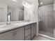 Bathroom featuring double vanity sinks, a large mirror and a walk-in shower at 3135 Laurel Oak Ln, Winter Haven, FL 33884