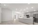 Open-concept kitchen featuring stainless steel appliances and a large island with a breakfast bar at 3135 Laurel Oak Ln, Winter Haven, FL 33884