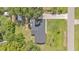 Aerial view of home with expansive lawn, long driveway, mature trees and a small shed in a large backyard at 3235 Sandpiper Ln, Mulberry, FL 33860