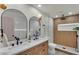 Modern bathroom featuring a double sink vanity and a walk-in shower with updated fixtures at 3235 Sandpiper Ln, Mulberry, FL 33860