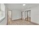 Spacious room featuring wood-look floors and an ensuite bath and closet with sliding mirror doors at 3235 Sandpiper Ln, Mulberry, FL 33860