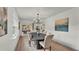 Elegant dining room with modern chandelier, stylish table setting, and view to the outdoor space at 3235 Sandpiper Ln, Mulberry, FL 33860