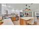 Modern kitchen featuring two-tone cabinetry, stainless steel appliances, and an island with barstool seating at 3235 Sandpiper Ln, Mulberry, FL 33860