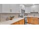Close-up of a well-appointed kitchen showcasing white countertops, stylish backsplash, and stainless steel appliances at 3235 Sandpiper Ln, Mulberry, FL 33860