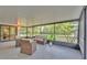 Enjoy the view from this spacious screened patio with comfortable seating, perfect for relaxing outdoors at 3235 Sandpiper Ln, Mulberry, FL 33860
