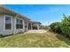 This back yard features a sliding glass door, patio area with grill, and a grassy space at 3783 Wildcat Run, Lakeland, FL 33810