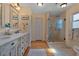 This bathroom features a double sink, plenty of cabinet space, and walk-in shower with glass doors at 3783 Wildcat Run, Lakeland, FL 33810
